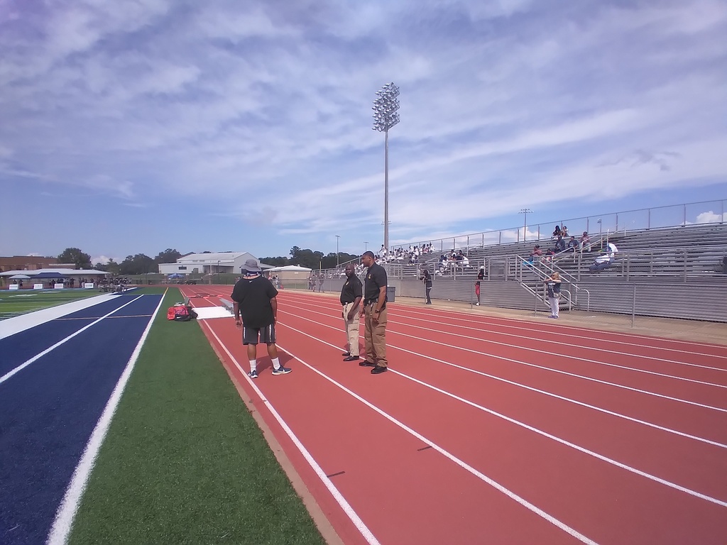 Officer Bingham accompanying the varsity football team